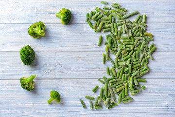 Frozen vegetables on wooden background