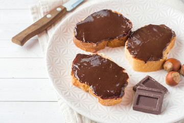 Sandwiches with chocolate hazelnut spread on the plate.