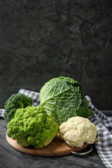 Different kinds of cabbage on wooden board