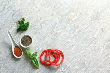 Fresh aromatic herbs with spices and pepper on light background
