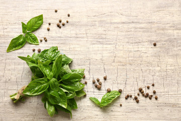 Fresh aromatic basil with spices on light background