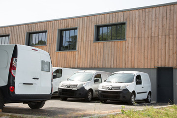 delivery van in row service trucks and cars front entrance warehouse distribution logistic plant © OceanProd