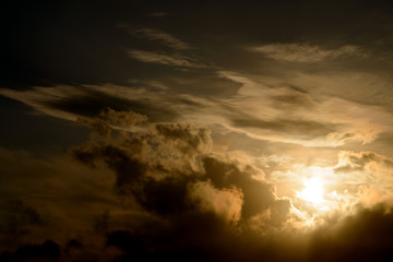 Dramatic sunset sky with dark clouds.