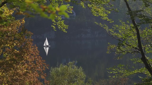 Lonely sail on the atumn lake