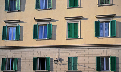 Fototapeta na wymiar Tuscany, Italy, wooden windows of the facade of a historic building