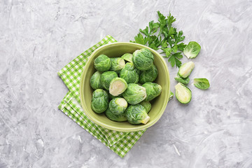 Bowl with fresh brussels sprouts on table, top view