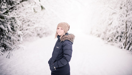 Fototapeta na wymiar young woman on snowy path