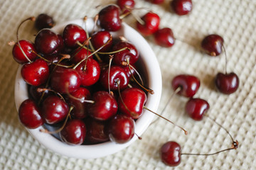 Fresh cherry on plate on towel background. fresh ripe cherries. sweet cherries.