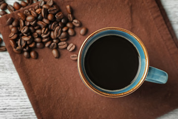 Cup of hot coffee on table