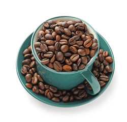 Cup with coffee beans on white background