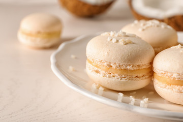Plate with sweet macaroons on light table