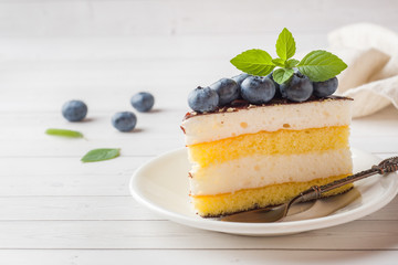 Cake of a souffle with glaze and fresh blueberries. copy space