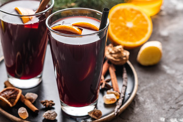 Hot mulled wine with spices, apple and orange on christmas background. Copy space.