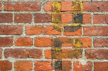 brick wall background with fading yellow letters