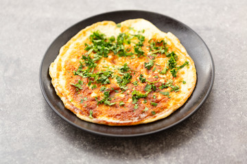 Scrambled eggs with herbs in the plate. Delicious breakfast