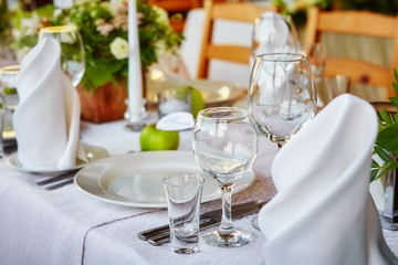 Simple and elegant table for a festive or wedding event, decorated in green and white