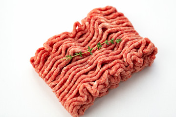 Beef and pork minced with fresh thyme isolated on white