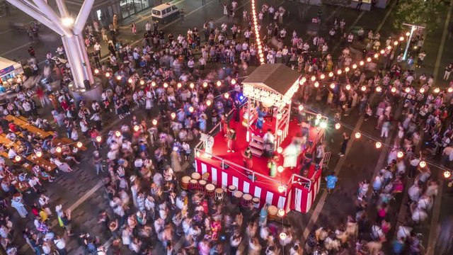 Japanese summer festival “Bon-odori” in time-lapse. People dancing in circle