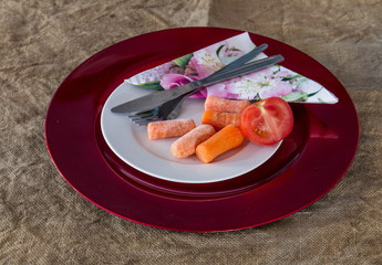 Leftovers on a plate together with eating utensils image with copy space in landscape format