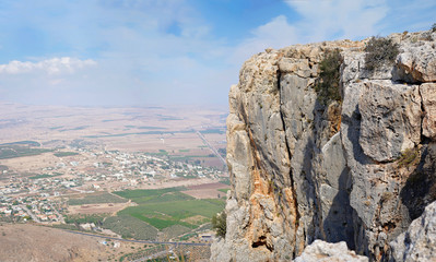 Fototapeta na wymiar Mount Arbel vertical cliff towering magnificently over Sea of Galilee and looking out towards Golan Heights and Hermon near Tiberias in Israel. Nature reserve and national park views