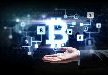 cryptocurrency, financial technology and business concept - buisnessman hand with virtual bitcoin block chain hologram over black background