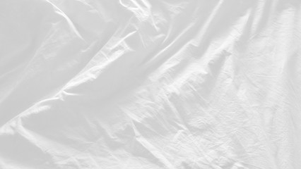 close up top view of white pillow on bed and with wrinkle messy blanket in bedroom, from sleeping in a long night. abstract texture for white background 