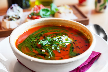 Traditional Italian tomato soup gazpacho with basil.