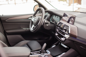 Interior of a modern passenger car with leather interior and wooden inserts