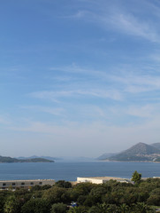 Fototapeta premium Sea, sky and distant mountains portrait