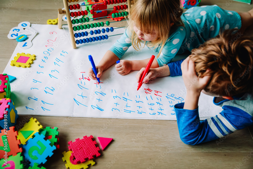 Wall mural little boy and girl learn to write and calculate numbers