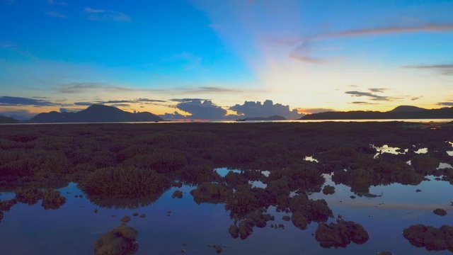 time lapse scenery sunrise above the coral reef coral reef emerges from the water at a reduced water level.during low tide we can see a lot of coral reef 