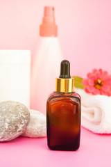 Beauty spa cosmetics, salon therapy concept. Glass bottle on pink background.