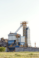 Fototapeta na wymiar Big group of grain dryers complex for drying wheat. Modern grain silo.