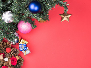 Top view of Beautiful Christmas wreath with gift boxes and christmas tree on red background. Holiday mood