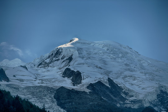 Summit Pointe Bravais Chamonix softly touched by sunrise with Pointe Bayeux and Glacier de Taconnaz in cloudless blue sky