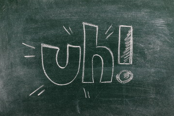 Obraz premium Comic surprise uh drawn on chalkboard, blackboard background and texture