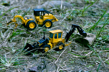 View from above looking at two excavator cars working in the woods.