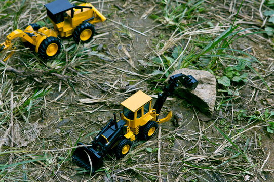 View from above looking at two excavator cars working in the woods.