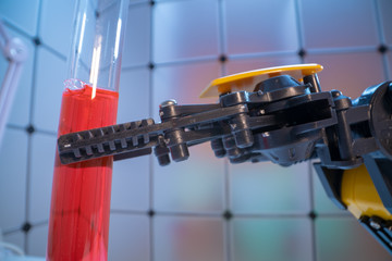 Test tube in robot arm. robot manipulates chemical tubes in the laboratory