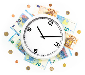 Clock surrounded by bills and euro coins