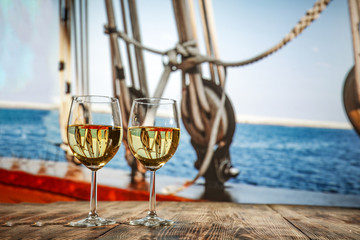 two single glasses of wine wiht free space for your bottle and blurred background. 