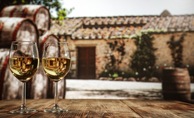 two single glasses of wine wiht free space for your bottle and blurred background. 