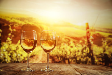 two single glasses of wine wiht free space for your bottle and blurred background. 