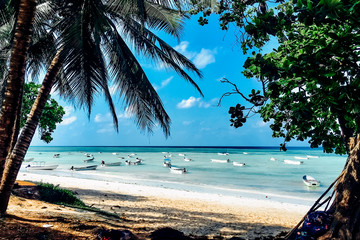 Paradise beach view with boats on ocean - obrazy, fototapety, plakaty