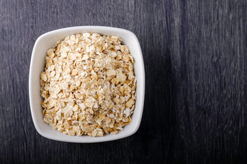 Oat bowl on dark background.