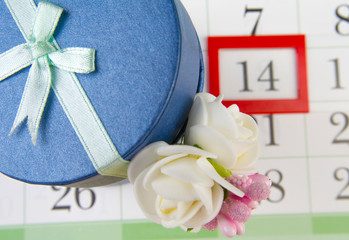 Gift on the background of the calendar with the marked date.