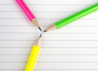 Colored pencils are on the notebook.