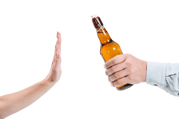 cropped image of woman rejecting bottle of beer isolated on white