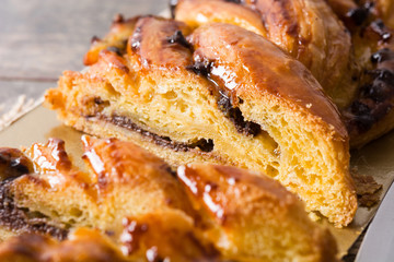 Homemade braid chocolate on wooden table. Close up
