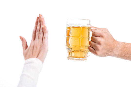 cropped image of woman rejecting glass of beer isolated on white